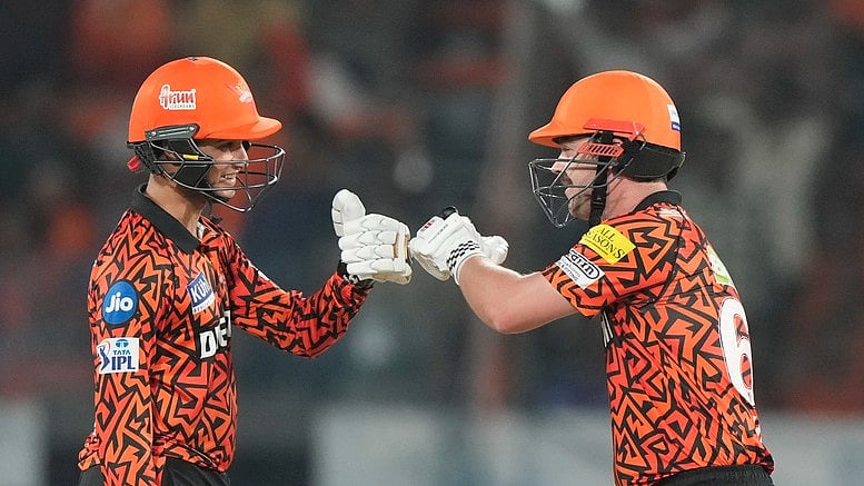 Sunrisers Hyderabad's Travis Head, right, celebrates his fifty runs with his batting partner Abhishek Sharma. - AP
