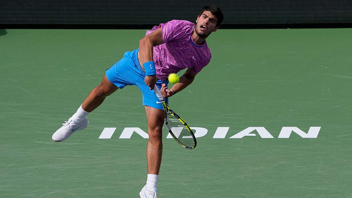 (Mark J Terrill/AP) : Carlos Alcaraz, of Spain, serves to Daniil Medvedev, of Russia, during the final match at the BNP Paribas Open.