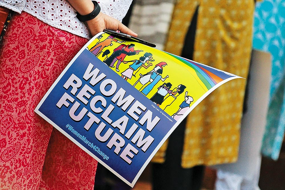 Raising Awareness: A woman holding a poster at a rally held in Mumbai to create awareness among voters, and demand social justice and equality for all - Photos: Getty Images