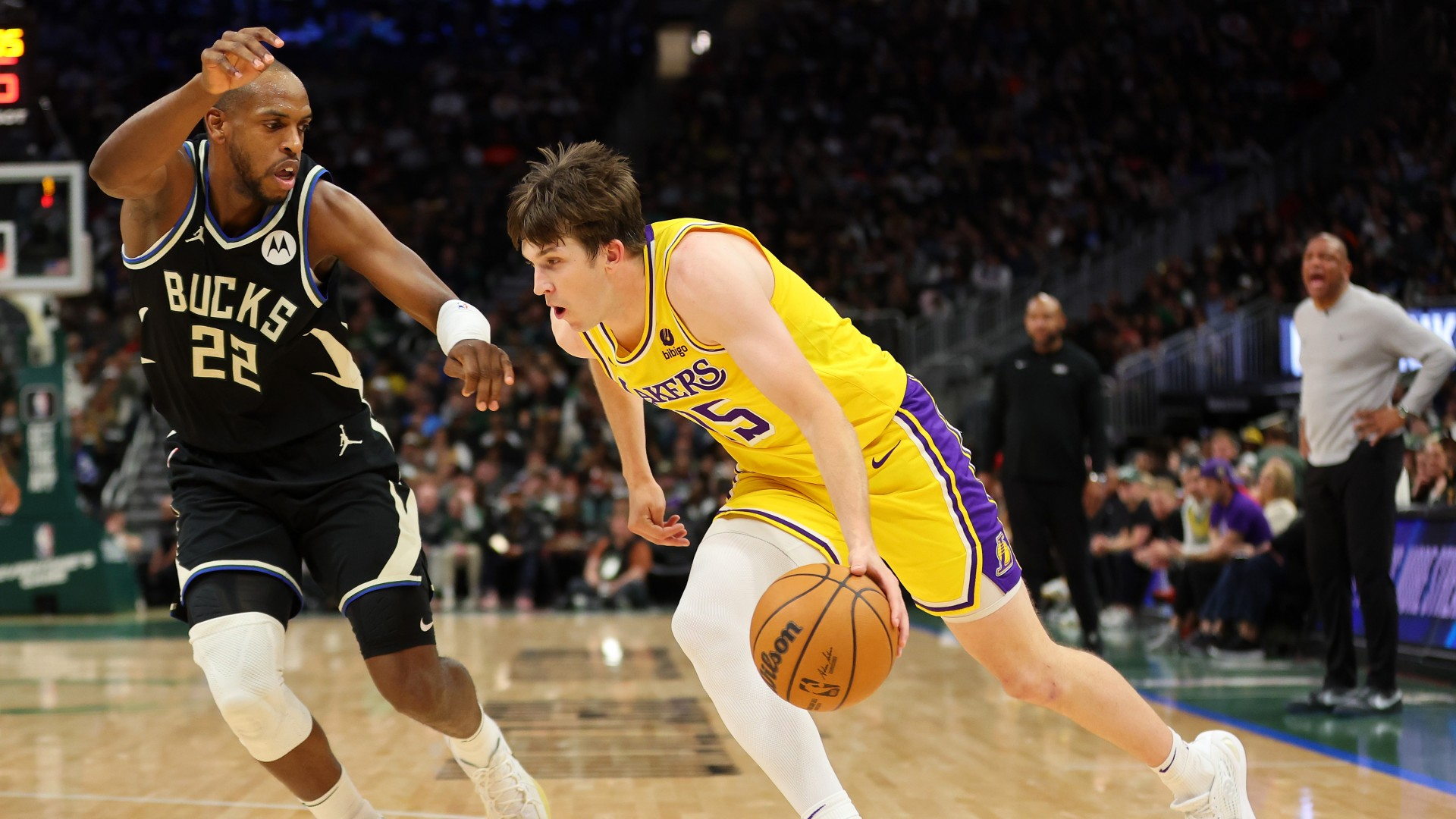 Austin Reaves #15 of the Los Angeles Lakers drives to the basket against Khris Middleton #22 of the Milwaukee Bucks during the second half of a game at Fiserv Forum on March 26, 2024. - null