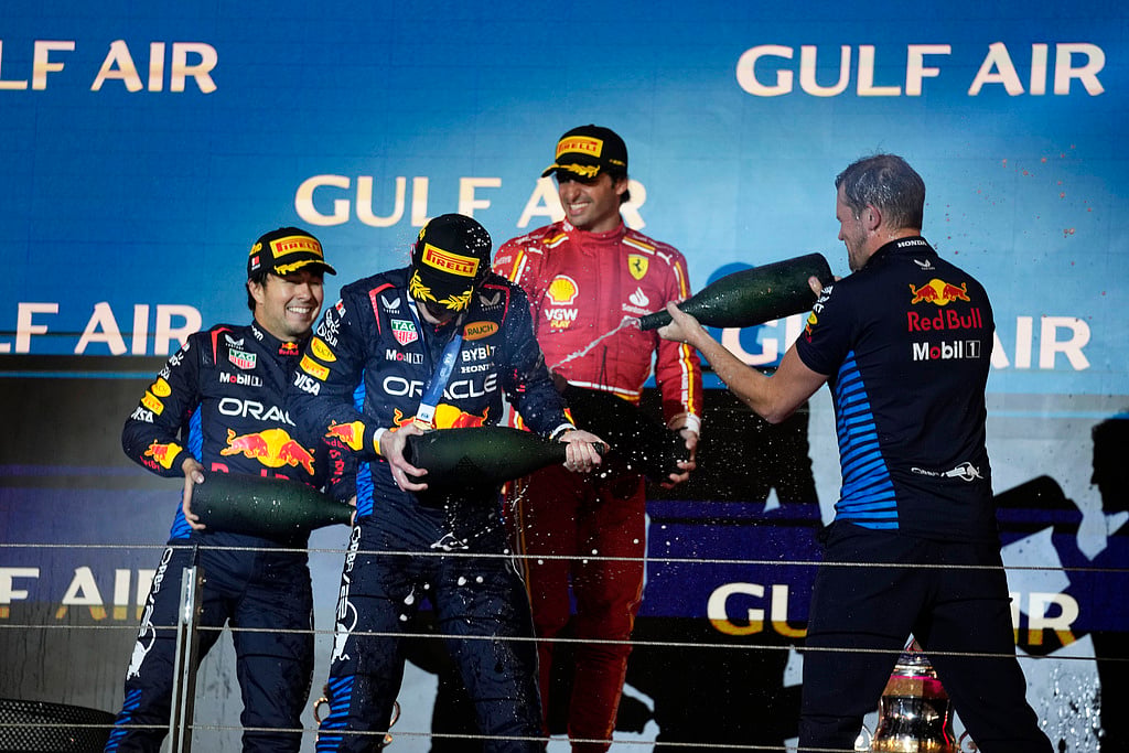 First place, Red Bull driver Max Verstappen of the Netherlands, second left, celebrates on the podium with second place, Red Bull driver Sergio Perez of Mexico, left, and third place, Ferrari driver Carlos Sainz of Spain, center, during the Formula One Bahrain Grand Prix at the Bahrain International Circuit in Sakhir, Bahrain, Saturday, March 2, 2024. 


 - (AP Photo/Darko Bandic)