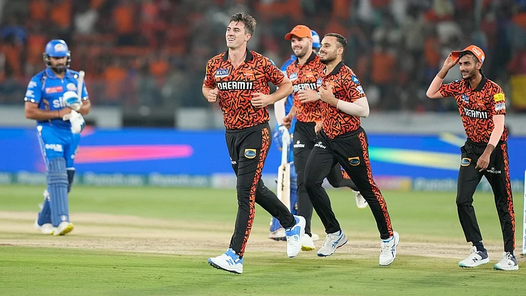 SRH players led by their skipper Pat Cummins (c) celebrate a MI wicket. - AP