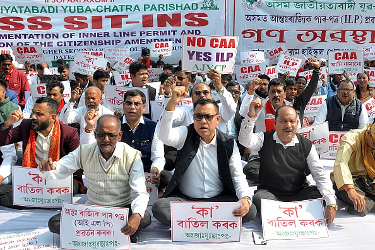 Members of Asom Jatiyatabadi Yuba Chatra Parishad are shouting slogans during a protest demanding the scrapping of the Citizenship Amendment Act - Getty Images