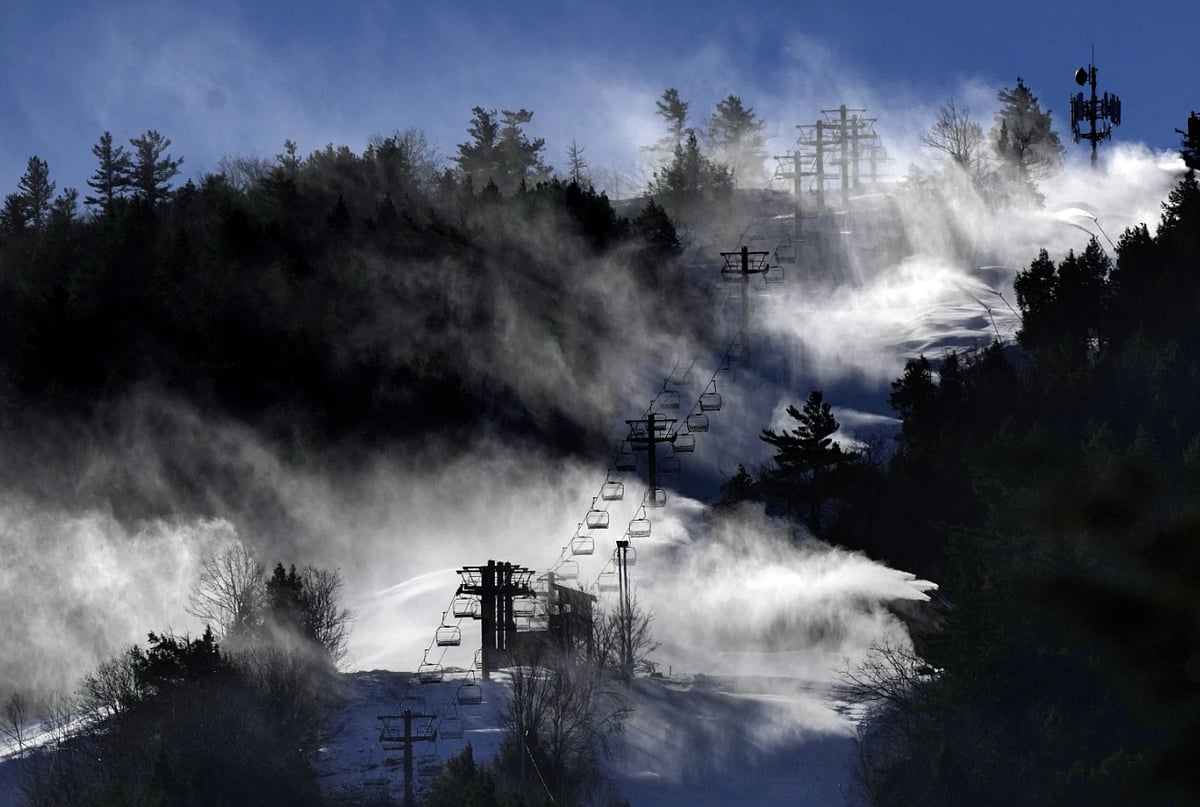 Snow is blown from snowmaking equipment near the summit of Pleasant Mountain ski resort - AP