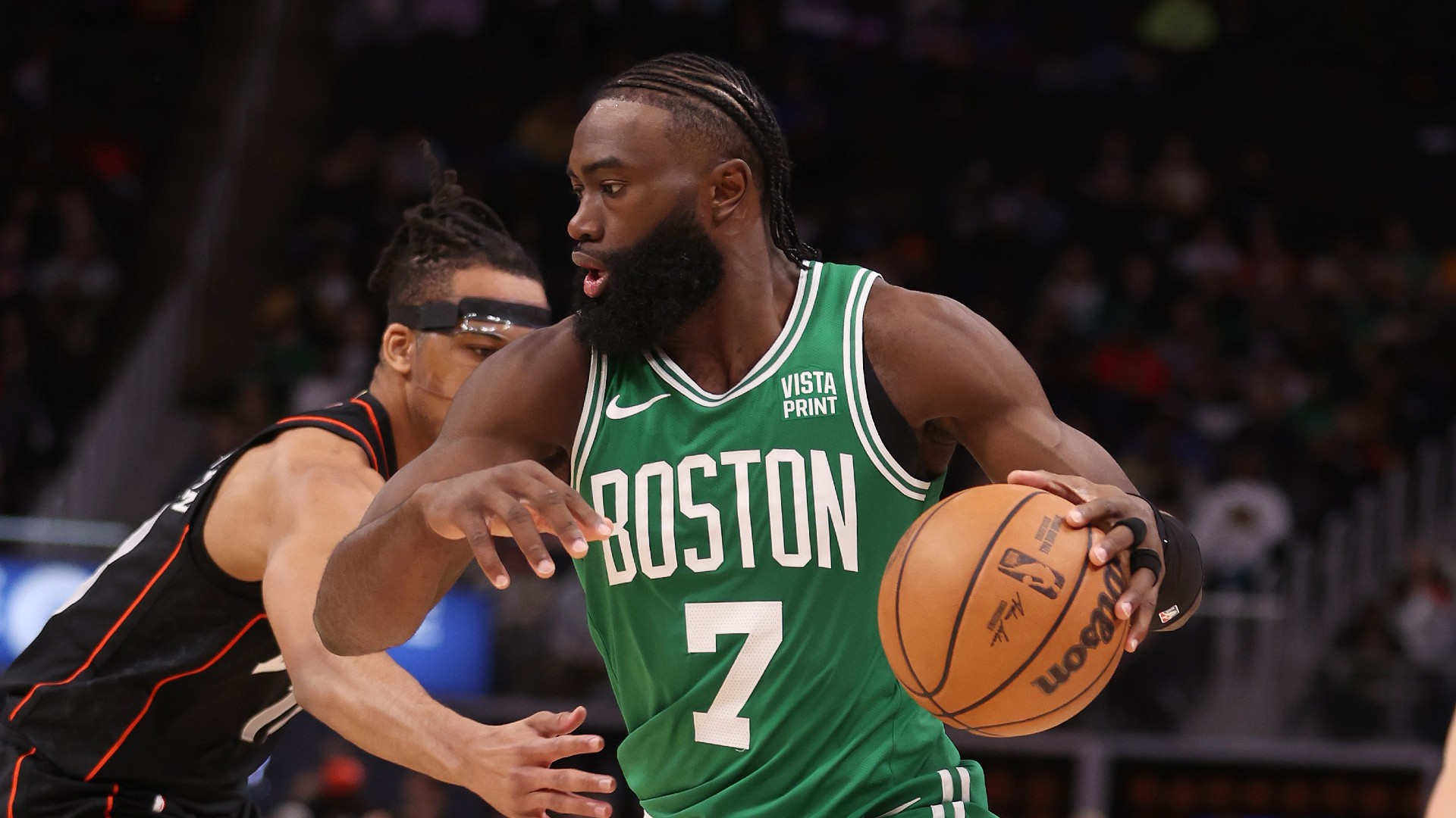 Jaylen Brown #7 of the Boston Celtics drives around Tosan Evbuomwan #18 of the Detroit Pistons during the first half at Little Caesars Arena on March 22, 2024 - null