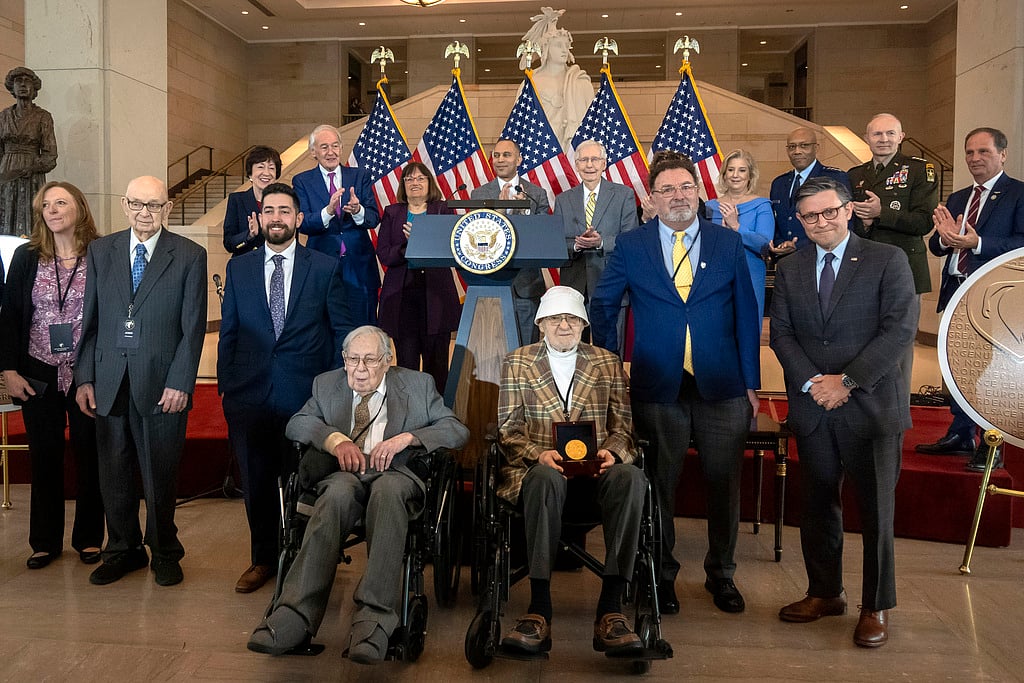AP : Ghost Army members John Christman, of Leesburg, N.J., second from left standing, Seymour Nussenbaum, of Monroe Township, N.J, in wheelchair at left, and Bernard Bluestein, of Hoffman Estates, Ill., in wheelchair at right, join military and congressional officials as members of their secretive WWII-era unit are presented with the Congressional Gold Medal during a ceremony on Capitol Hill, Thursday, March 21, 2024, in Washington. 