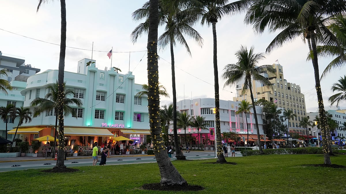 AP : Pedestrians walk along Ocean Drive with its beautiful Art Deco buildings in Miami Beach.