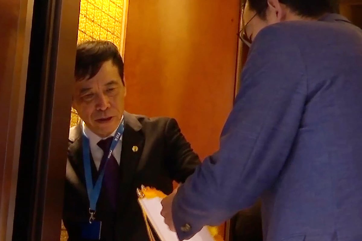 AP : In this image made from video, Chen Xuyuan, the then head of the Chinese Football Association, gets on an elevator in Shanghai on Oct. 24, 2019.