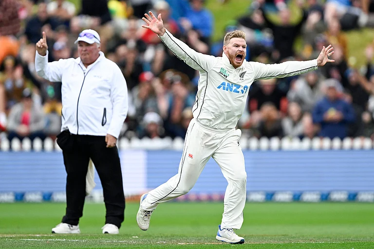 Glenn Phillips (right) celebrates the wicket of Cameron Green on day 3 of the first Test match between New Zealand and Australia at the Basin Reserve in Wellington on March 2, 2024. - Andrew Cornaga/Photosport via AP