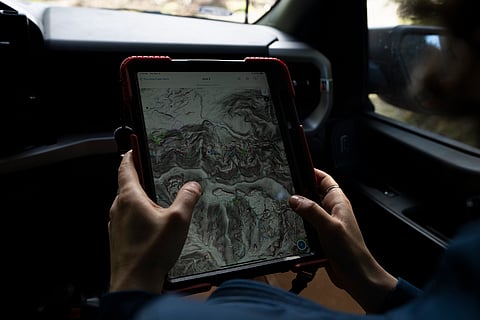 Washington State Department of Natural Resources geologist Emilie Richard looks at landslide mapping as she heads to examine the site of a potential landslide in the Capitol Forest, Thursday, March 14, 2024, in Olympia, Wash. 