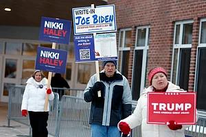 AP Photo/Michael Dwyer, File : Candidate supporters stand outside a polling location in the presidential primary elections.