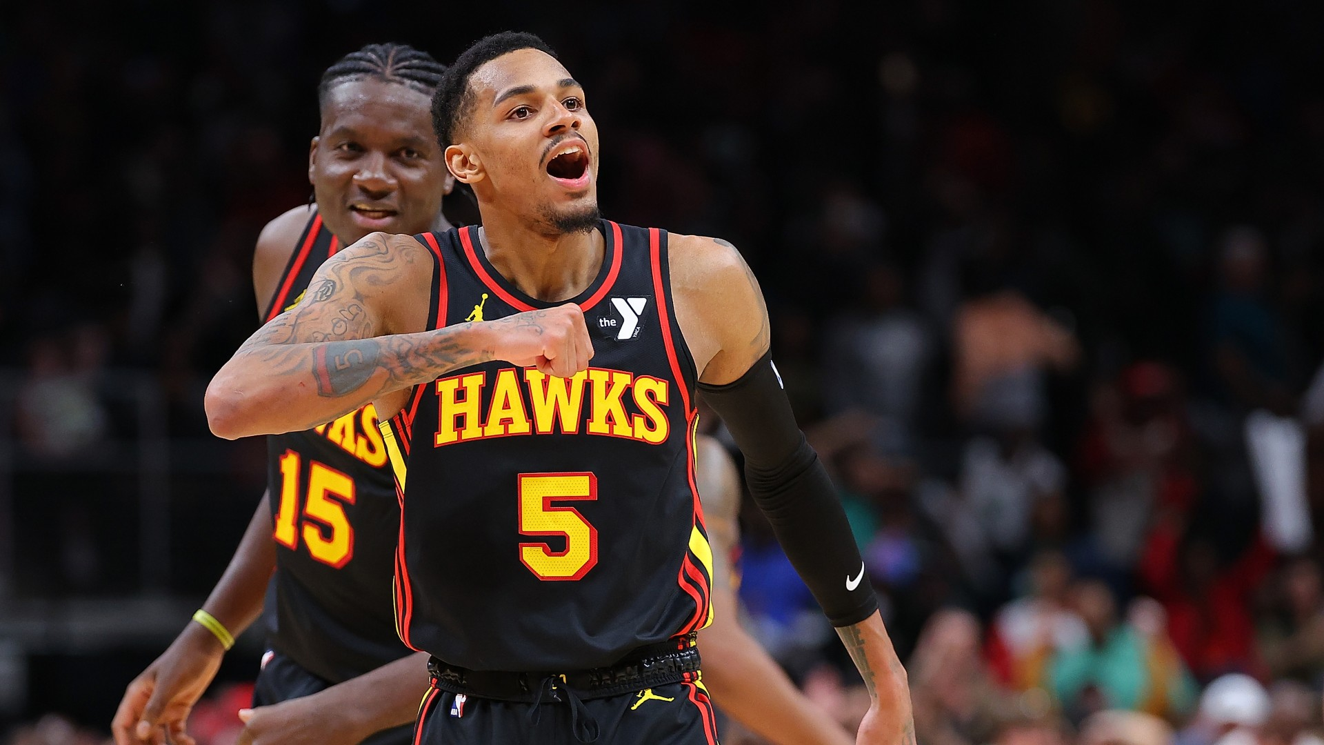 Dejounte Murray #5 of the Atlanta Hawks reacts after hitting the game-winning basket during overtime against Jrue Holiday #4 of the Boston Celtics at State Farm Arena on March 28, 2024.