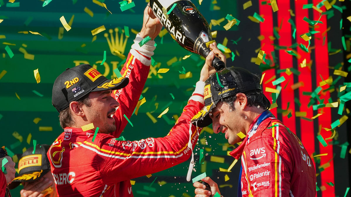 Second placed Ferrari driver Charles Leclerc, left, of Monaco pours champagne on teammate Carlos Sainz of Spain after his win at the Australian Formula One Grand Prix at Albert Park, in Melbourne, Australia, Sunday, March 24, 2024.  - (AP Photo/Scott Barbour)