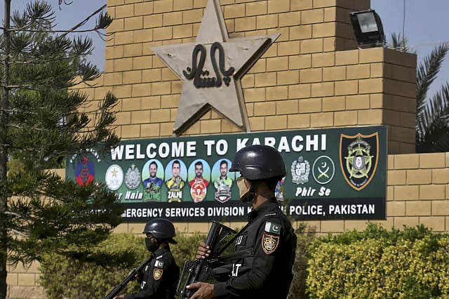 File : Pakistan police commandos stand guard outside the National Stadium in Karachi, during a training session of the Pakistan cricket team.