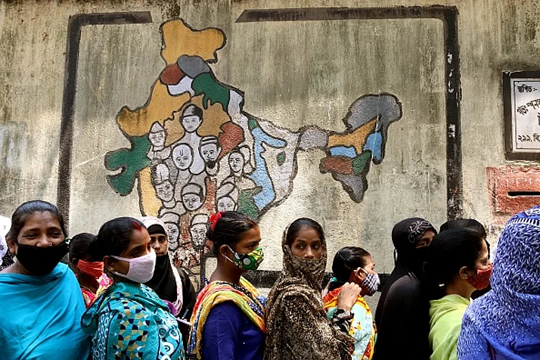 Voters stand in a queue at a polling station to cast their ballot during 8th phase of West Bengal assembly elections in Kolkata, India on 29th April, 2021. - Getty Images