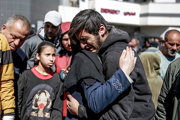 Getty Images : People mourn following an early morning incident when residents rushed toward aid trucks in Gaza City on February 29, 2024 |
