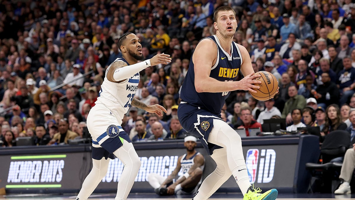 File : Nikola Jokic #15 of the Denver Nuggets drives against Monte Morris #23 of the Minnesota Timberwolves during the first quarter at Ball Arena on April 10, 2024.