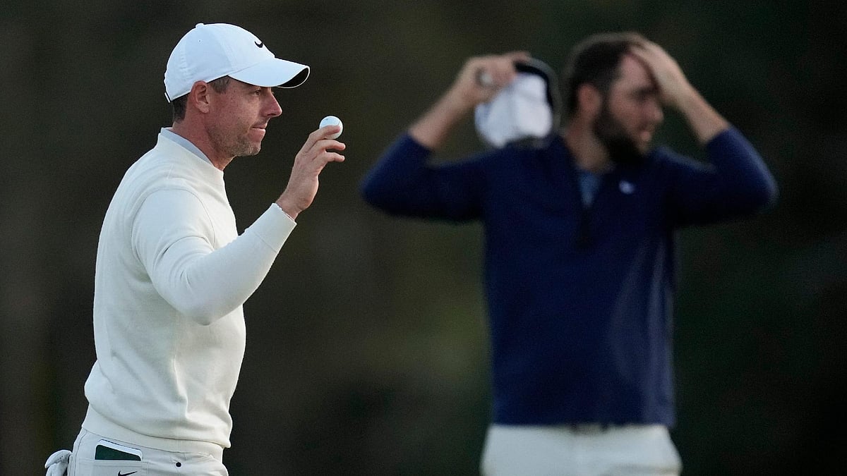 Ashley Landis/AP : Rory McIlroy (left) trailed Scottie Scheffler (background) by 10 shots at the halfway stage of the Masters.