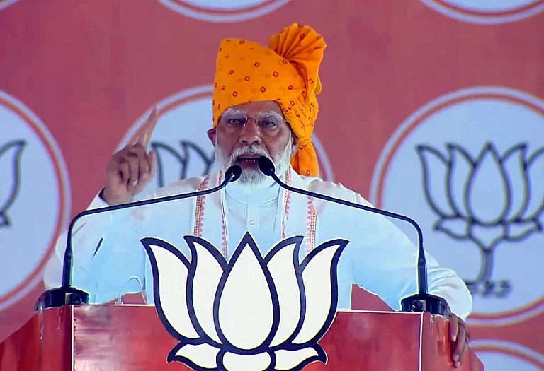 Prime Minister Narendra Modi addresses during a public meeting ahead of the second phase of Lok Sabha elections, in Banswara district. - null