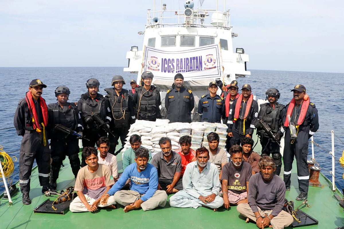 PTI : Indian Coast Guard (ICG) personnel with 14 crew members of a Pakistani boat after apprehending them from Indian waters | 