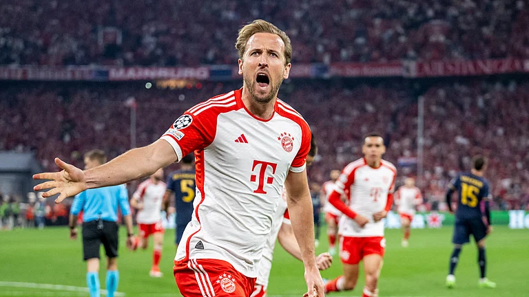 Harry Kane wheels off in celebration after scoring for Bayern Munich on Tuesday. - null