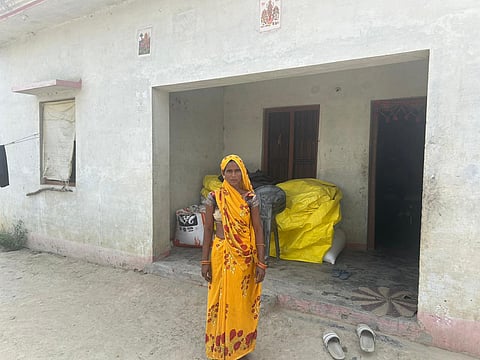 Vineetha in front of her house