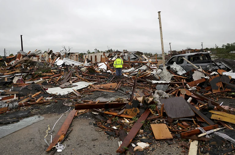 Man surrounded by tornado damage in Sulphur. - AP