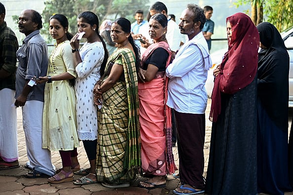 (Photo by R. SATISH BABU via Getty Images) : People queue to cast their vote at a polling station during the second phase of voting of India's general elections in Wayanad district in Kerala on April 26, 2024.