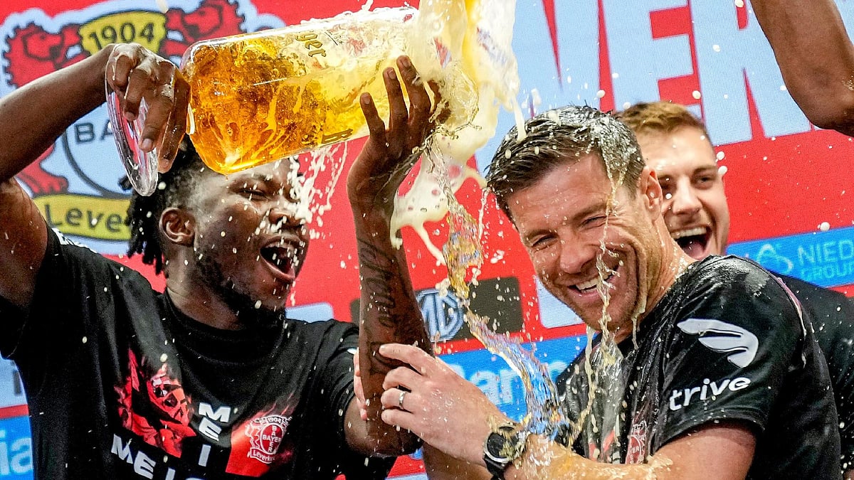 Leverkusen’s head coach Xabi Alonso, centre, is sprayed with beer after Bayer Leverkusen won the Bundesliga title (AP Photo/Martin Meissner) - AP Photo/Martin Meissner
