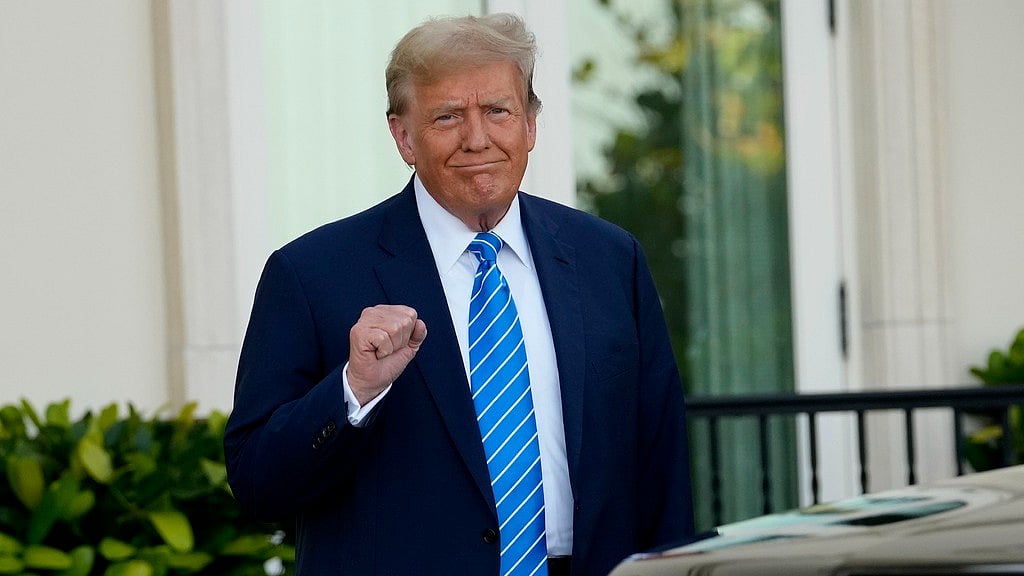 Donald Trump pumps his fist as he arrives for a GOP fundraiser, Saturday, April 6, 2024, in Palm Beach, Fla.  - AP
