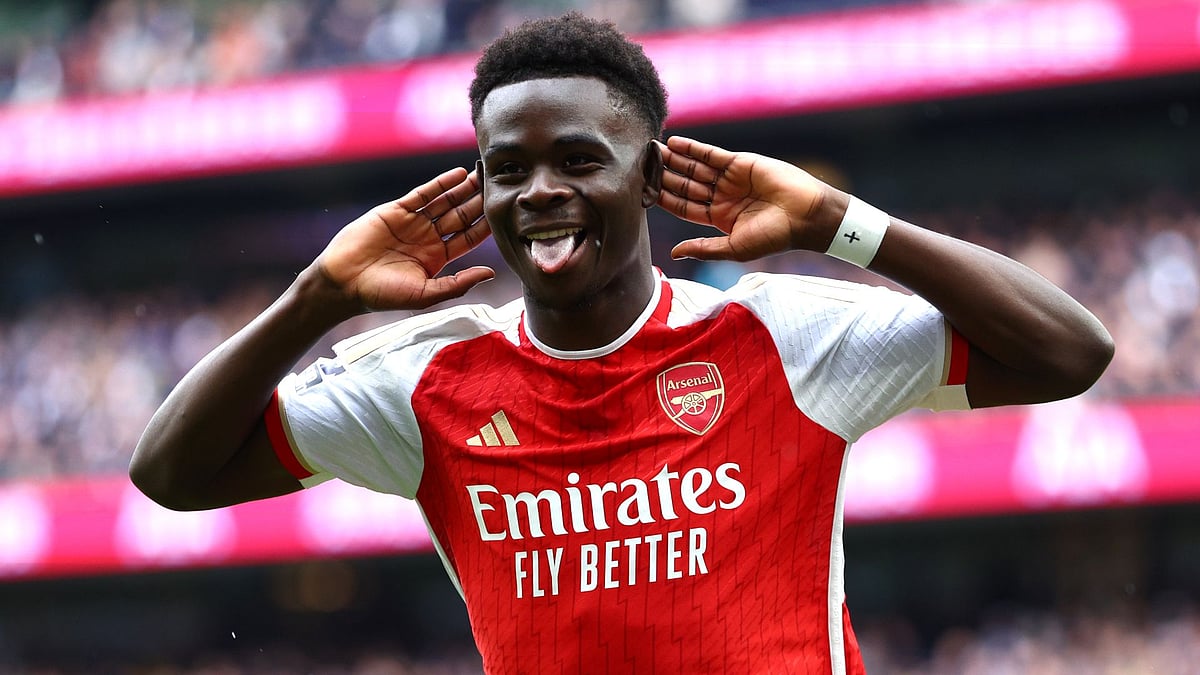 Saka celebrates scoring against Tottenham - null