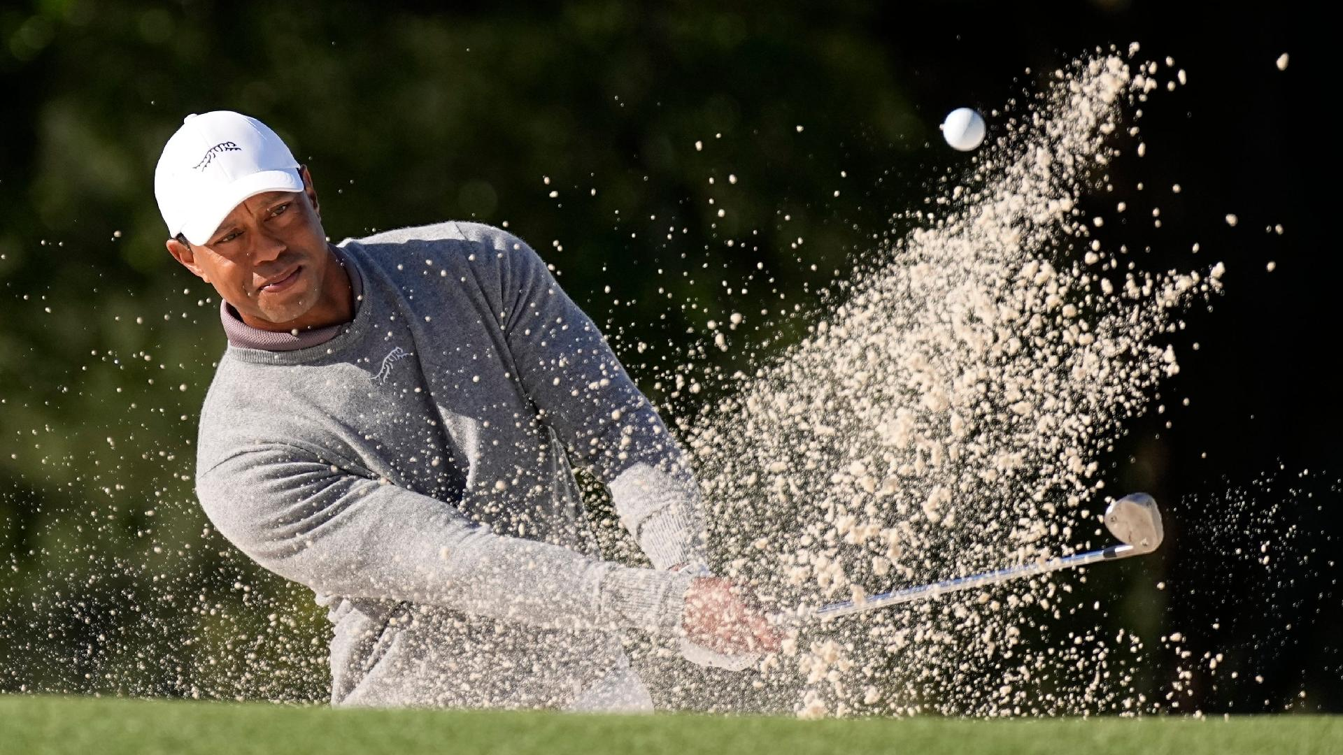 George Walker IV/AP : Tiger Woods hits from the bunker on the 18th hole during his first round of 73 in the 88th Masters.