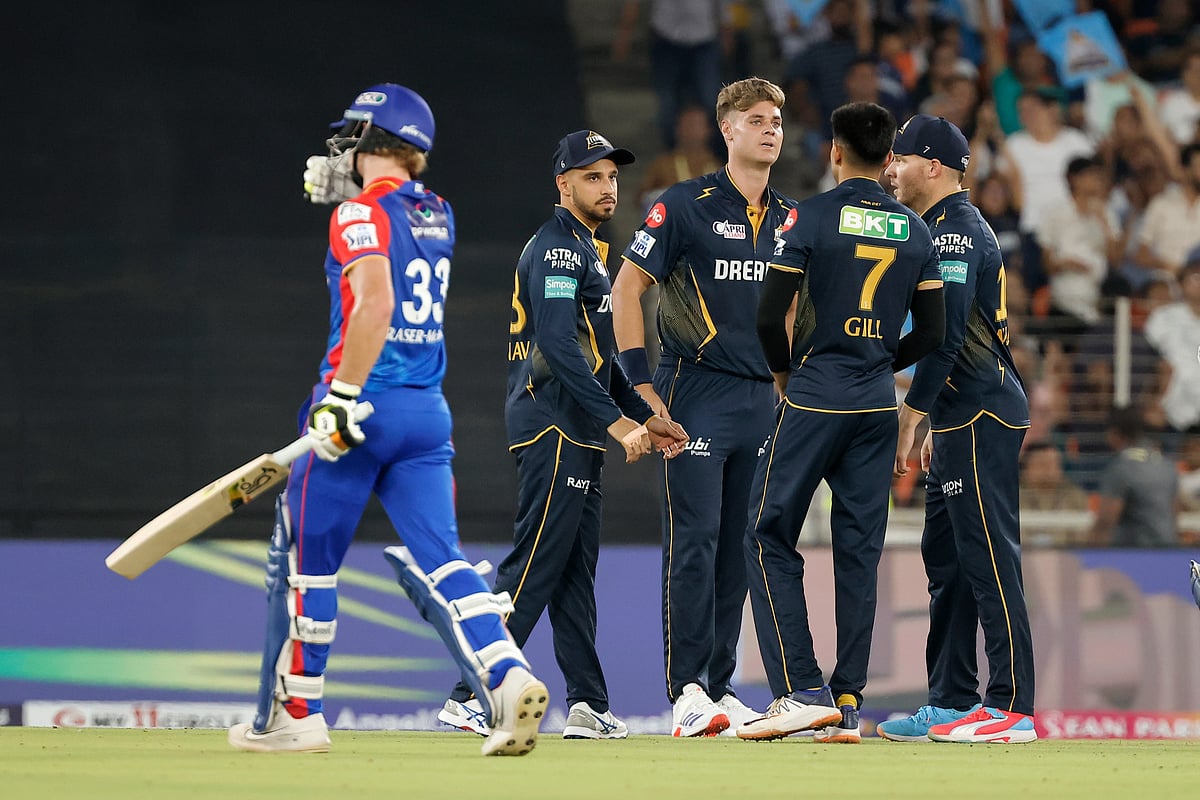 Gujarat Titans' Spencer Johnson, center, celebrates the wicket of Delhi Capitals' Jake Fraser-McGurk, left, during the Indian Premier League cricket match between Delhi Capitals and Gujarat Titans in Ahmedabad, India, Wednesday, April 17, 2024.  - (AP Photo/Pravin Indrekar)



