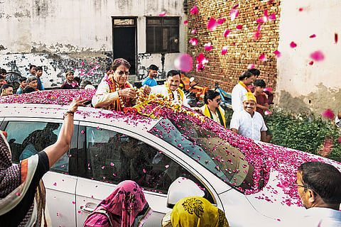 Among Supporters: Govil being showered with rose petals as he drives through the lanes of Chachoi village in Hapur