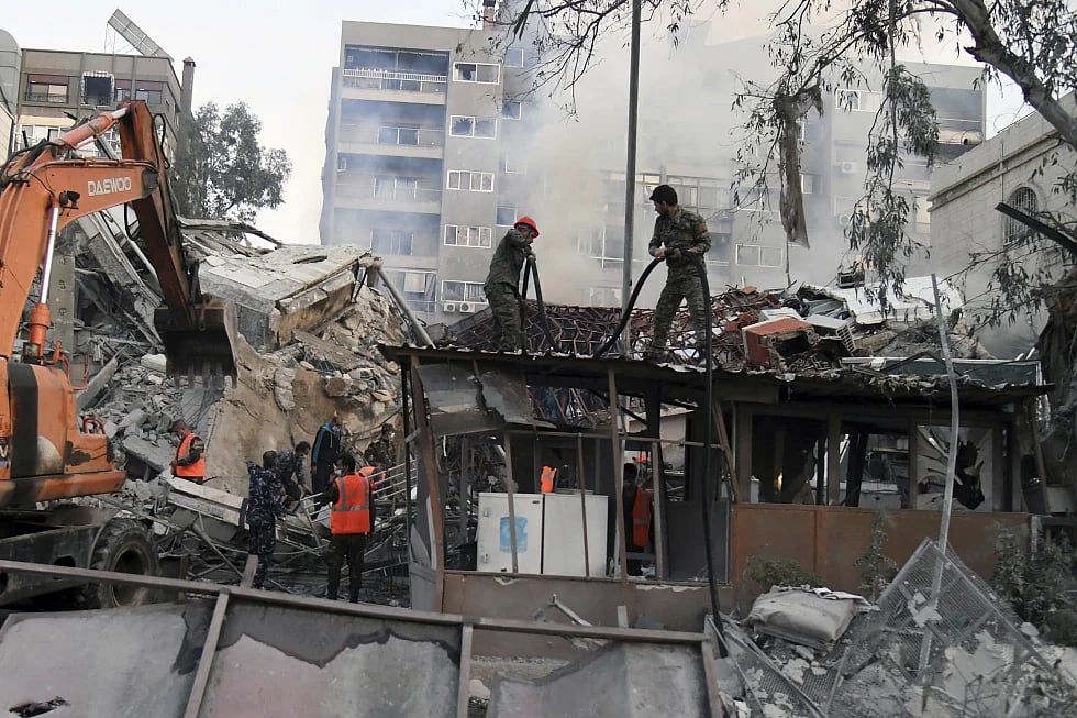 AP : The workers clear the rubble at a destroyed building struck by Israeli jets in Damascus, Syria |