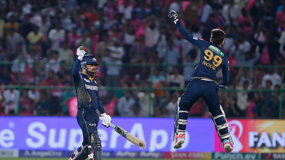 Gujarat Titans' Rashid Khan, left, and teammate Noor Ahmad celebrate their team's victory during the Indian Premier League cricket match against Rajasthan Royals in Jaipur. - AP Photo/Surjeet Yadav