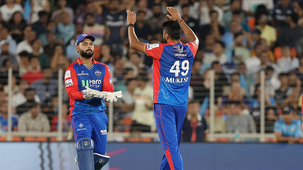 Delhi Capitals' Mukesh Kumar, right, celebrates with captain Rishabh Pant the wicket of Gujarat Titans' Wriddhiman Saha during the Indian Premier League cricket match between Delhi Capitals and Gujarat Titans in Ahmedabad. - AP Photo/Pravin Indrekar