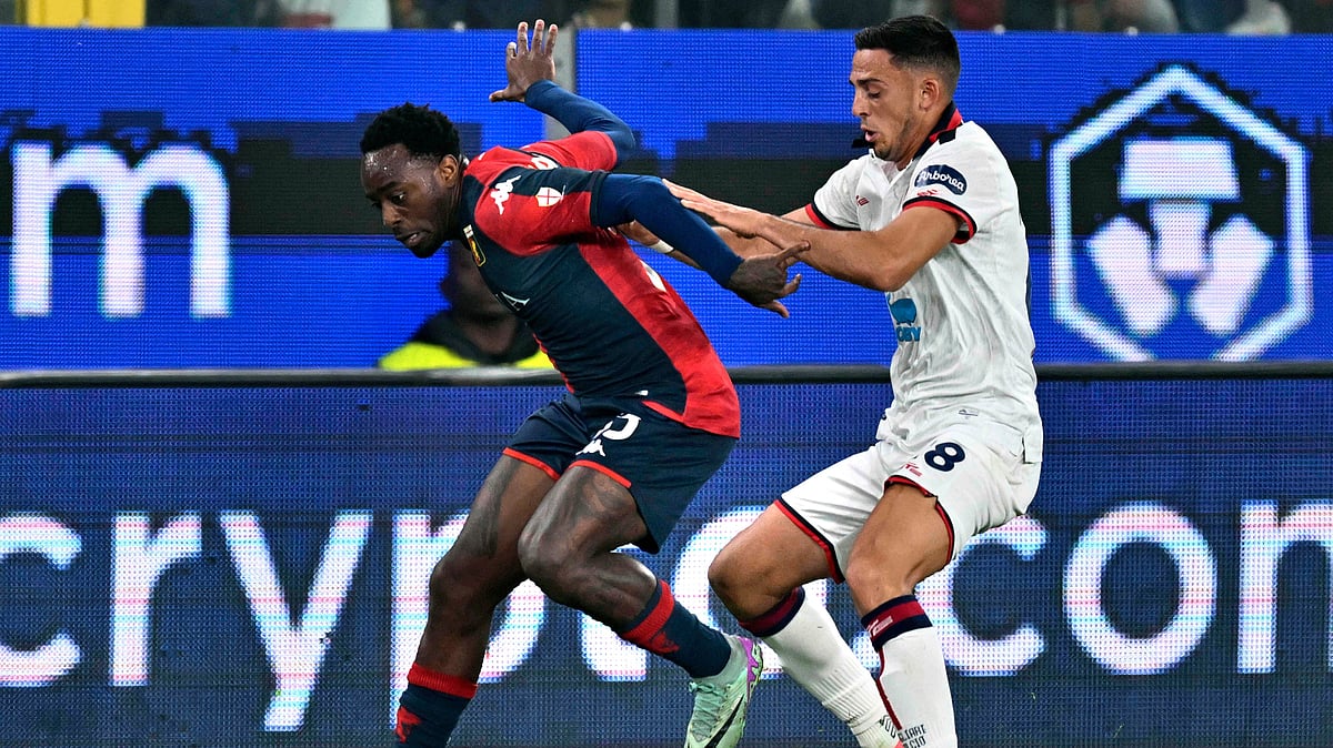 
During a Serie A soccer match, Genoa's Ridgeciano Haps and Cagliari's Nahitan Nandez vie for possession of the ball. - AP