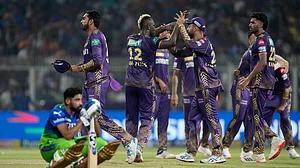 AP/Bikas Das : Royal Challengers Bengaluru's Mohammed Siraj sits dejected as Kolkata Knight Riders celebrate their win in match 36 of Indian Premier League 2024 at Eden Gardens.