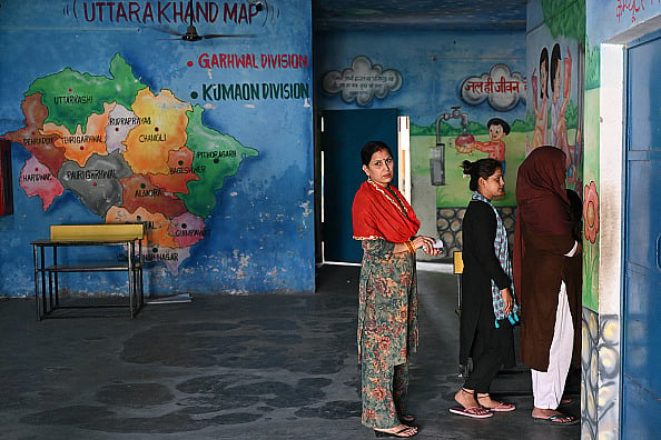 (Photo by ARUN SANKAR via Getty Images) : Voters wait in queue at a polling station to cast their ballot during the first phase of voting of India's general elections in Haridwar, Uttarakhand state, on April 19, 2024. 