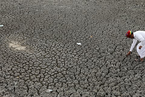 A farmer showing his dry field in Bikaner, Rajasthan.