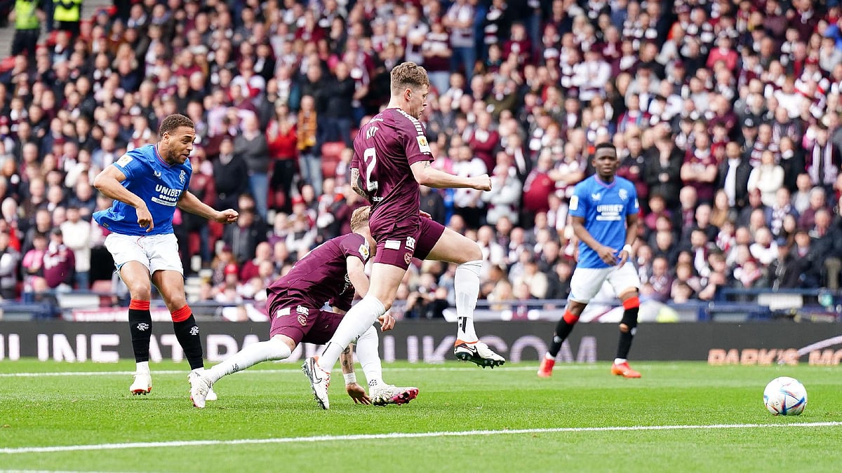 Andrew Milligan/PA : Rangers’ Cyriel Dessers (left) scores against Hearts.