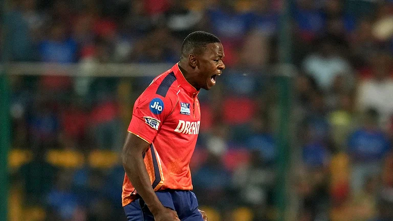 Punjab Kings' Kagiso Rabada celebrates the dismissal of Royal Challengers Bengaluru's captain Faf du Plessis during the Indian Premier League cricket match between Royal Challengers Bengaluru and Punjab Kings in Bengaluru, India, Monday, March 25, 2024. - (AP Photo/Aijaz Rahi)