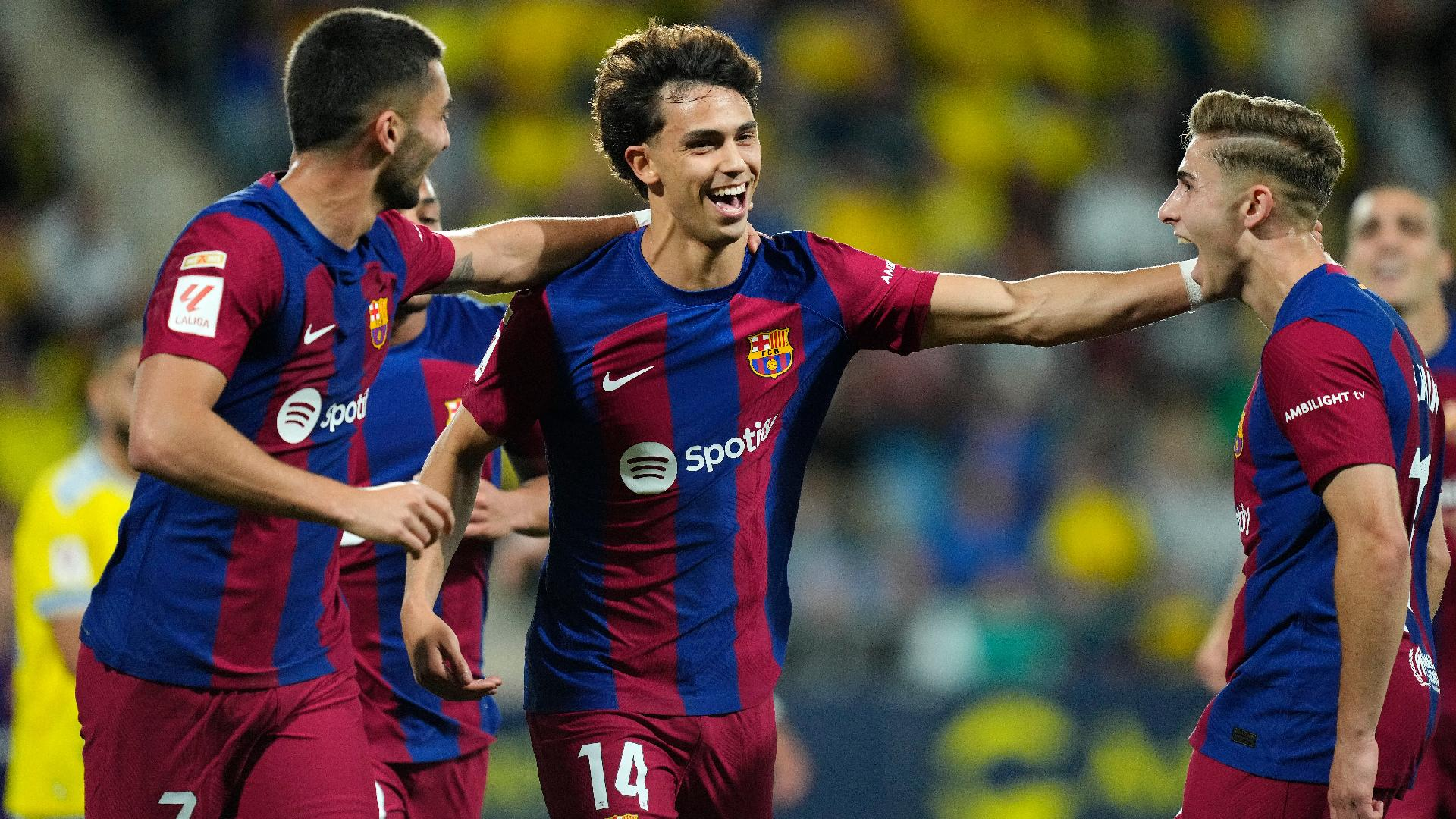 Jose Breton/AP : Barcelona’s Joao Felix, centre, is congratulated after his overhead kick gave his side the lead at Cadiz.