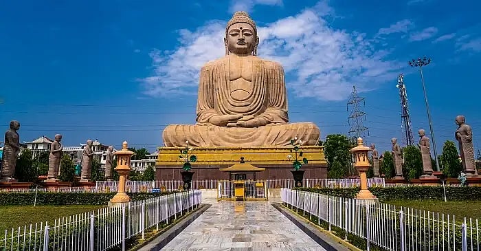 A large stone statue of a seated Buddha in Bodh Gaya.
