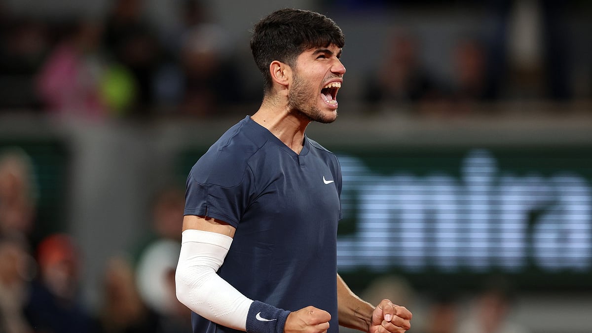 Carlos Alcaraz celebrates after converting match point.