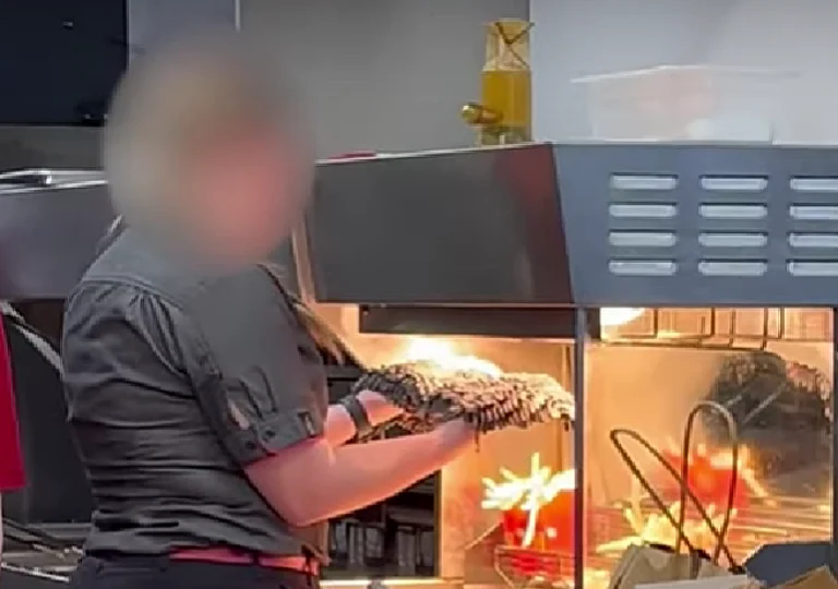 McDonald’s employee was caught drying a mop under heat lamps near fries. - null