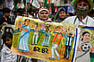 Samir Jana/Hindustan Times via Getty Images : An All India Trinamool Congress (AITC) supporter holds a poster during a rally before nomination file for General Election 2024 at Hazra on May 10, 2024 in Kolkata, India