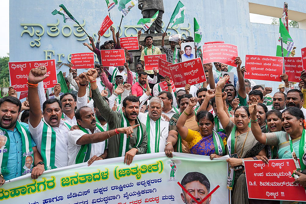 JD(S) workers raise slogans during a protest