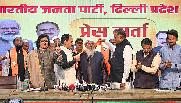 Sanchit Khanna/Hindustan Times via Getty Images) : Virendra Sachdeva, President of Delhi BJP along with Leader of Opposition Ramvir Singh Bidhuri makes the Muslim Beneficiaries of PM Narendra Modi's various schemes join BJP at Delhi BJP Office, Pant Marg, on March 2, 2024 in New Delhi, India.